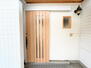 横田３（北松本駅）　２３９９万円 【玄関/リフォーム前】お家の印象を決める木目調の玄関扉。玄関ポーチはタイル張りで仕上げる予定です。