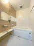 阪神住建グランディール阿倍野 ウッド調のアクセントパネルが施された浴室です。棚が設置されておりシャンプーなどの小物類を置くことが可